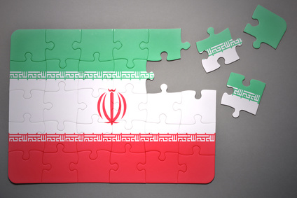 broken puzzle with the national flag of iran on a gray background