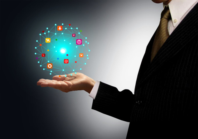 Businessman holding a ball with information technology icons
