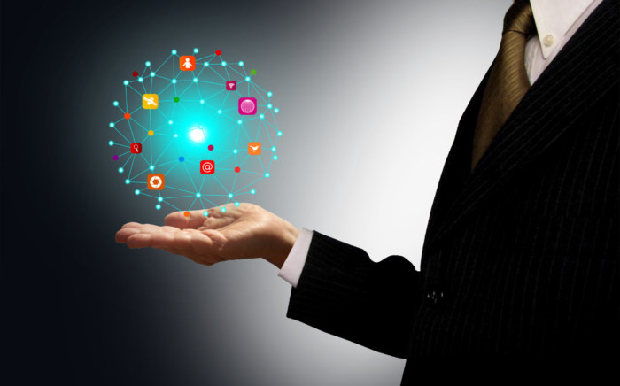 Businessman holding a ball with information technology icons